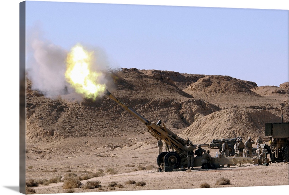 Flame and smoke emerge from the muzzle of an M198 Howitzer
