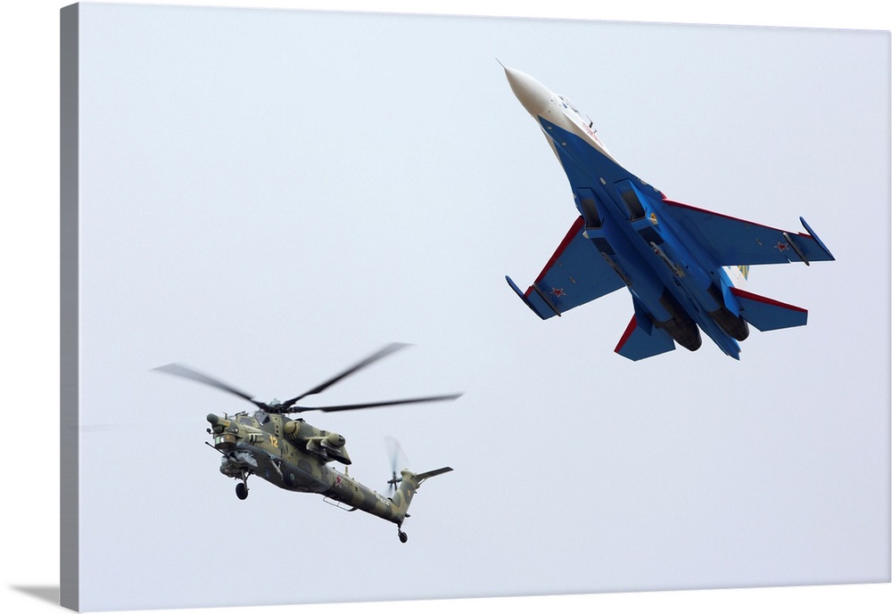 Formation flight of a Russian Su-27 and a Mil Mi-28N helicopter.