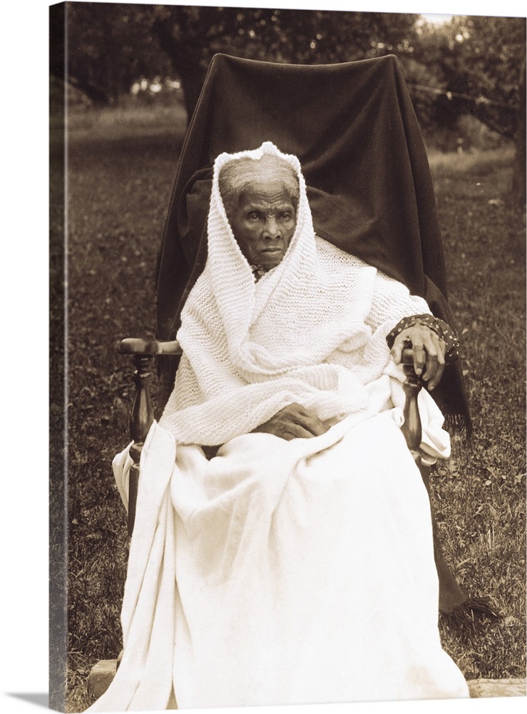 Full length portrait of Harriet Tubman seated in a chair.