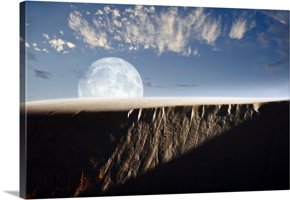 Full moon rising above a sand dune.