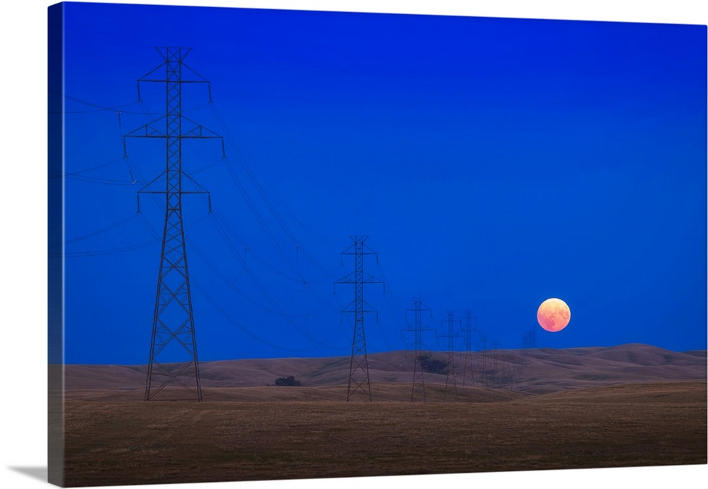 Full Moon Rising At The End Of A Long Line Of High Tension Towers In Alberta, Canada