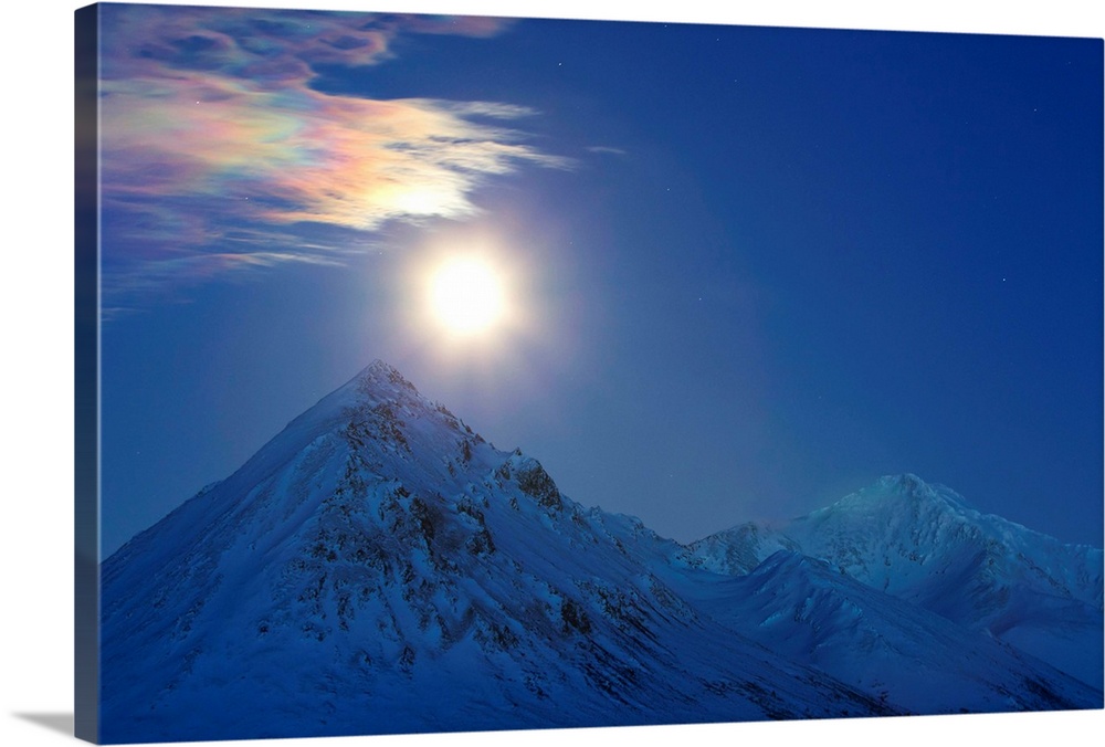 Full moon with rainbow clouds over Ogilvie Mountains, Tombstone Park, Dempster Highway, Canada.