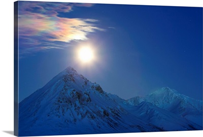 Full moon with rainbow clouds over Ogilvie Mountains, Canada