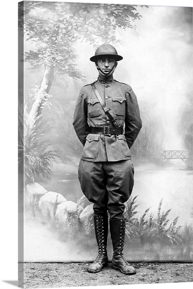 Harry S. Truman standing in front of a standard postcard backdrop during the first World War.