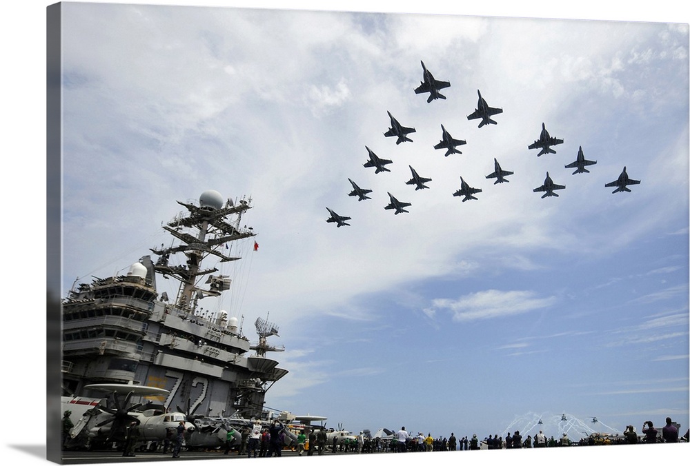 Atlantic Ocean, August 2, 2012 - Helicopters fire flares as jets fly in formation above the flight deck of the Nimitz-clas...
