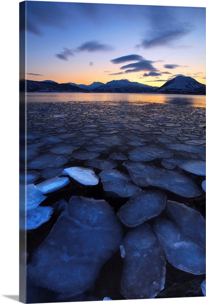 A rare sight in Tjeldsundet, Troms County, Norway. Ice flakes drifting in the sunset looking towards the mountains on Tjel...