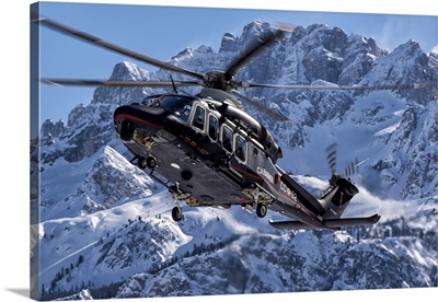 Italian Arma Dei Carabinieri AW-139 Helicopter Flys By A Snowcapped Mountain In Italy