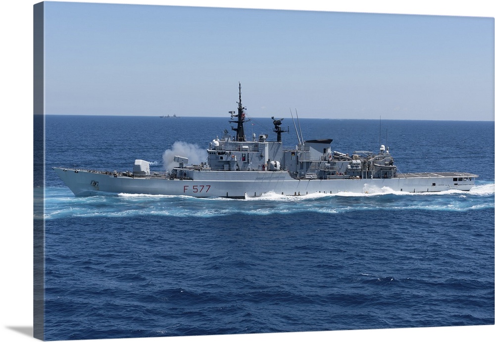 Italian Navy frigate Zeffiro firing its 127mm gun.