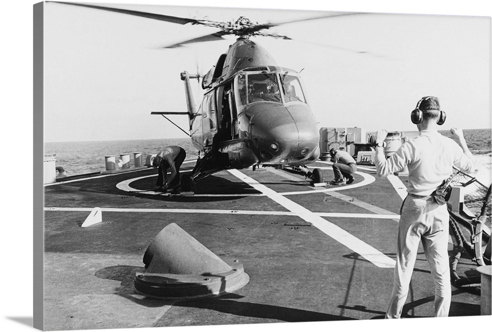 July 1969 - The Landing Signal Officer aboard USS Coontz (DLG-9), signals to the pilot of a Kaman UH-2 Seasprite helicopte...