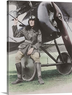 Lieutenant Earl Carroll, prominent composer, seated on wheel of his fast scout airplane