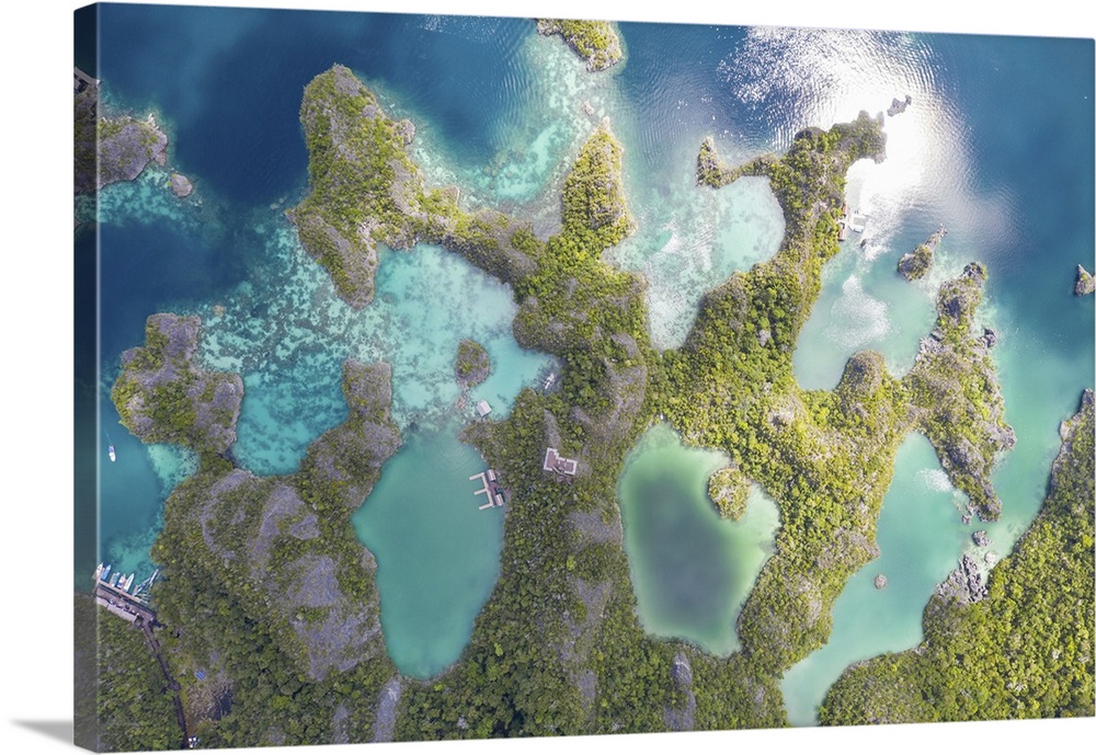 Limestone islands rise around a beautiful lagoon seascape in Raja Ampat, Indonesia.