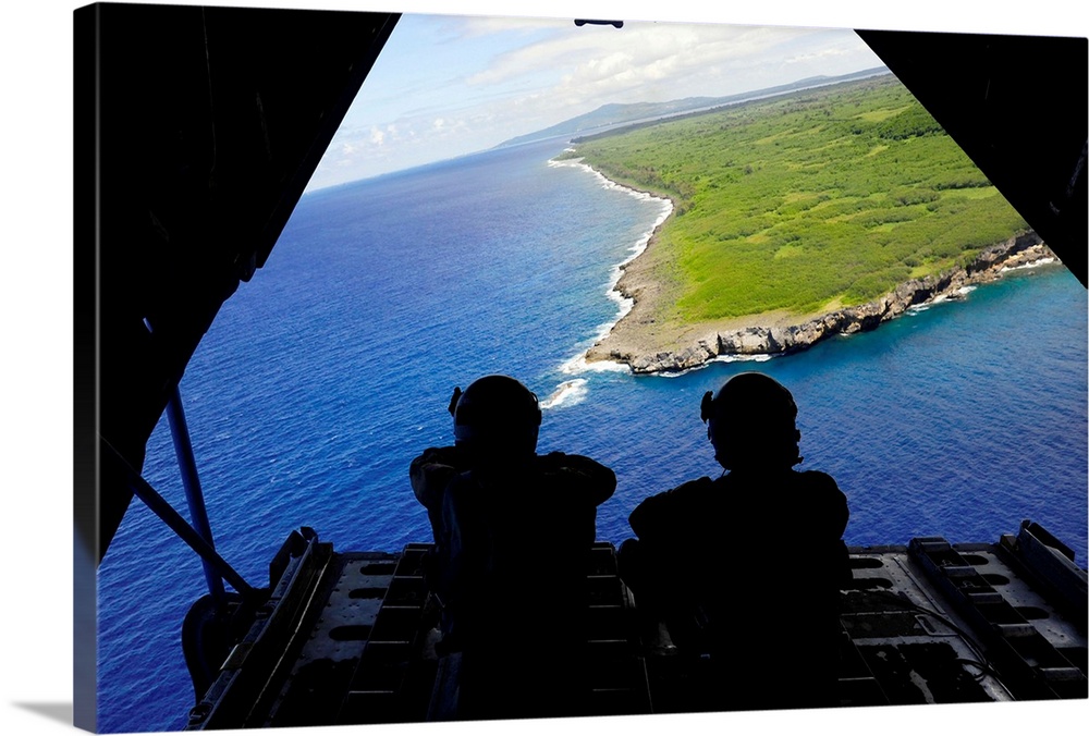 February 23, 2011 - Loadmasters admire the view from the back of a C-130 Hercules over Tumon Bay, near Guam, during Exerci...
