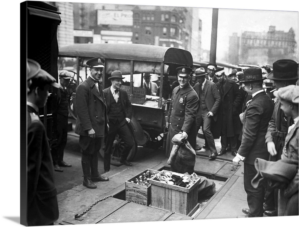March 23, 1923 - Police officials destroying confiscated booze during the era of the Prohibition.