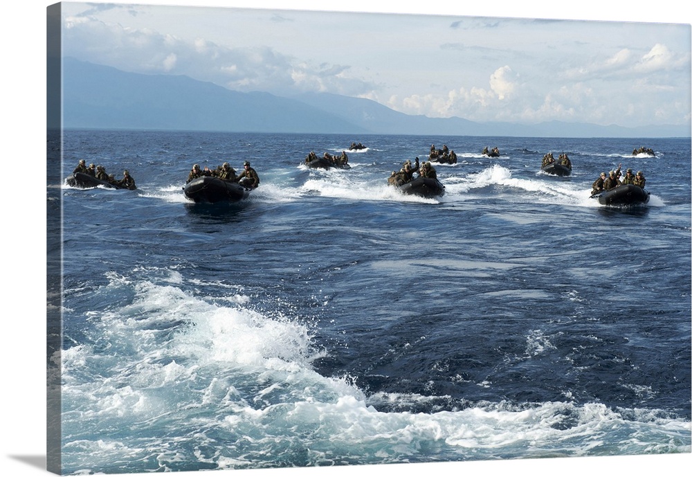 Marines in combat rubber raiding crafts transit the Sulu Sea.