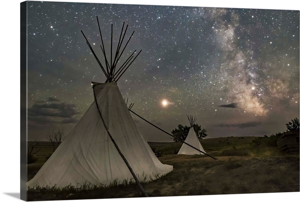 Mars and the Milky Way over the tipis in Grasslands National Park, Saskatchewan, Canada.