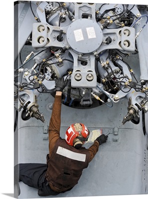 Mechanic performs an inspection on a MH-60S Seahawk