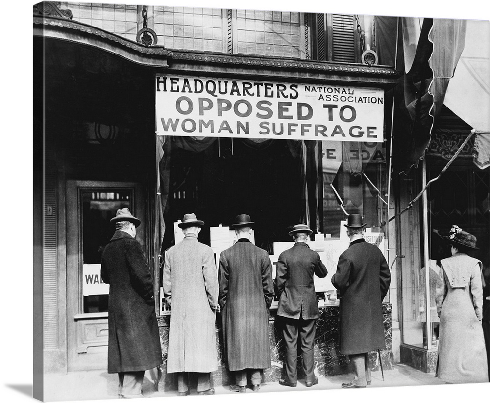 Men looking at material posted in the window of the National Anti-Suffrage Association headquarters.