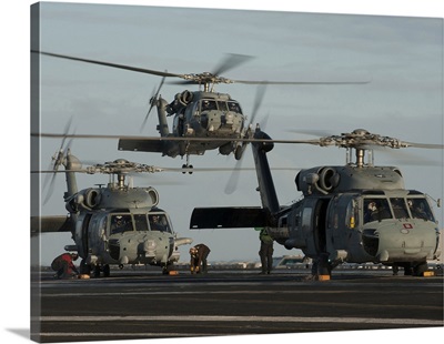 Military Helicopters Land On The Flight Deck Of USS Carl Vinson