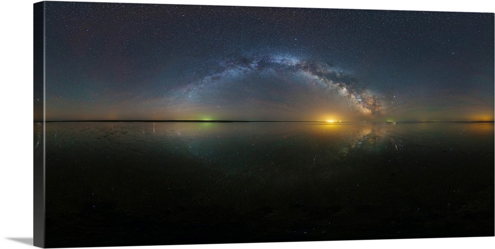 Milky Way with reflection of stars over Lake Elton salt lake in Russia.