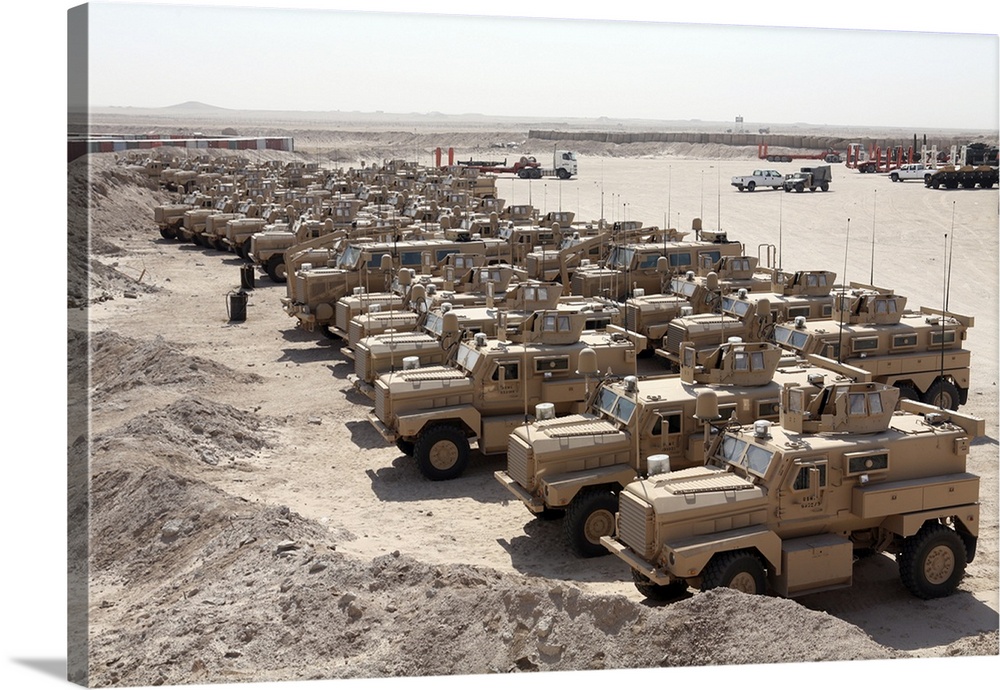 Al Taqaddum, Iraq, September 4, 2007 - More than 30 Mine Resistant Ambush Protected vehicles sit in a lot here waiting for...