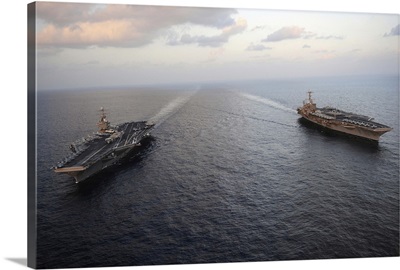 Nimitz-class aircraft carriers transit the Arabian Sea