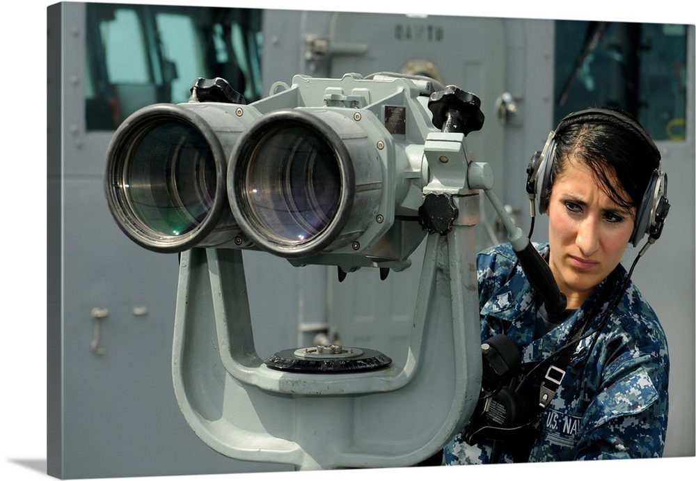 Operations Specialist looks out from the port bridge wing aboard USS Blue Ridge.
