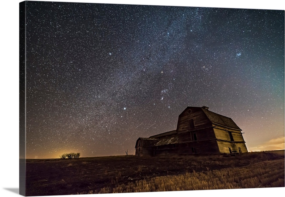 Orion and the winter Milky Way over an old barn in Alberta, Canada.