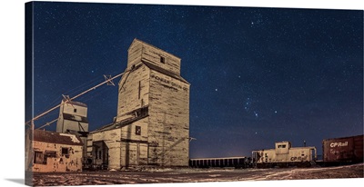 Orion And The Winter Stars Rising Behind Grain Elevators In Mossleigh, Canada