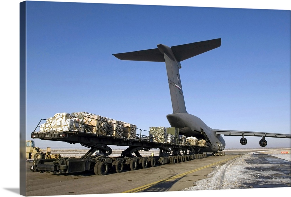 Photograph of cargo being loaded into a plane.