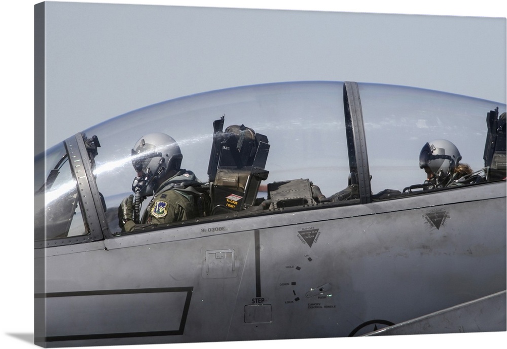 Pilot and female weapon systems officer (WSO) in the cockpit of an F-15E Eagle.