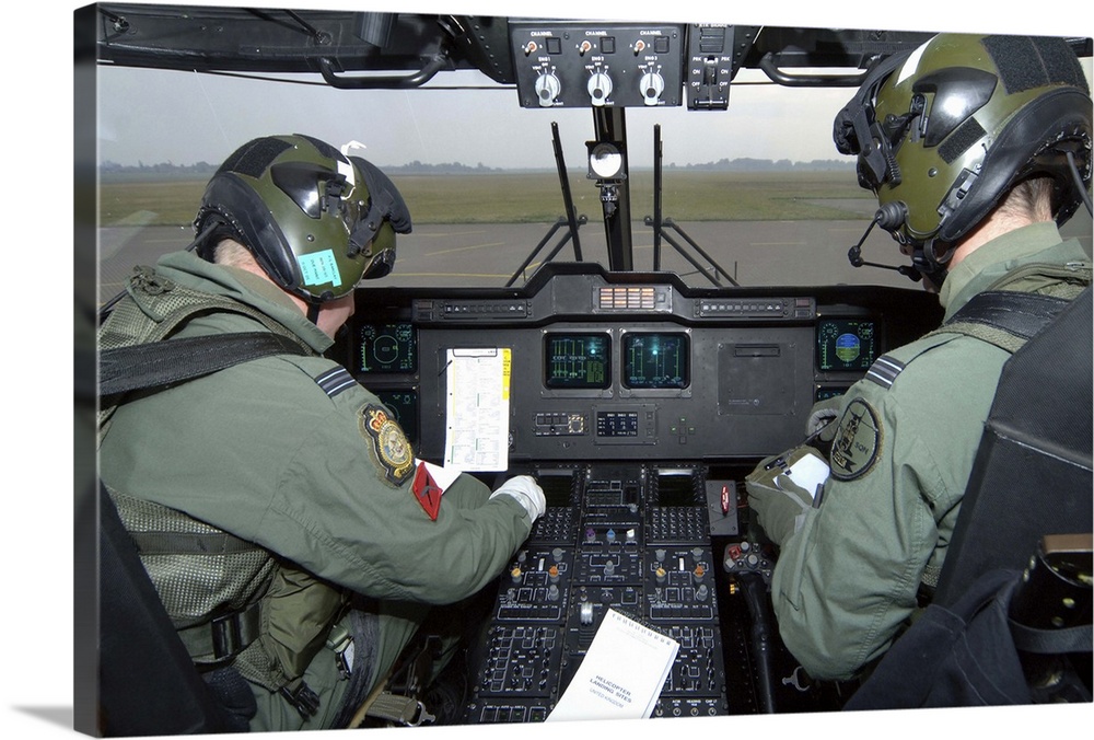 Pilots inside the cockpit of a Royal Air Force Merlin Helicopter at RAF Lyneham.