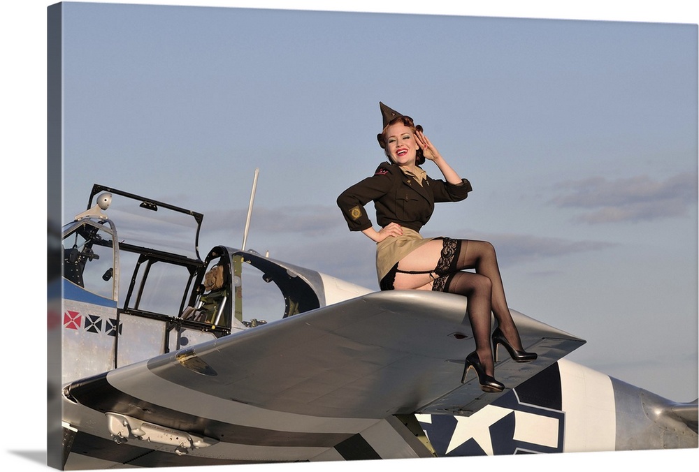Pin-up girl sitting on the wing of a P-51 Mustang fighter plane.