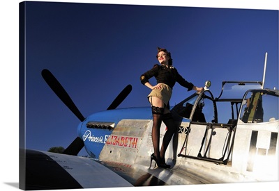Pin-up girl standing on the wing of a P-51 Mustang