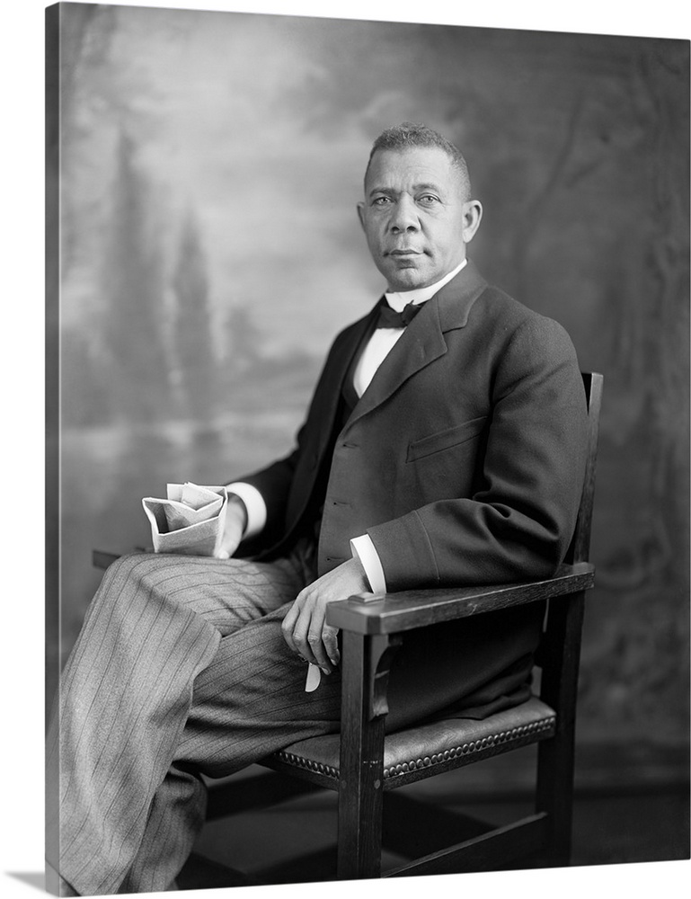Portrait of Booker T. Washington sitting in a chair.