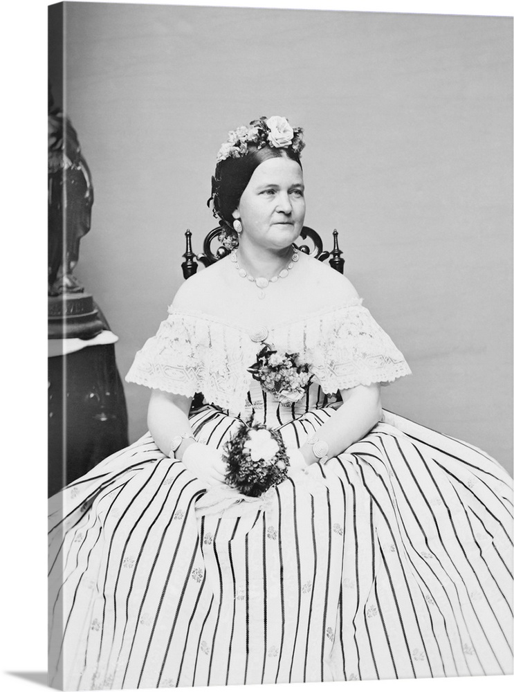 A seated portrait of First Lady Mary Todd Lincoln in an impressive hoop skirt. Taken circa 1861.