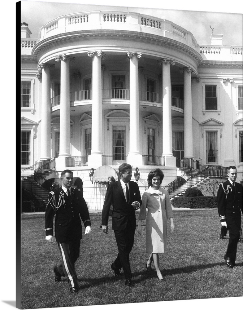 President John F. Kennedy and the First Lady in front of White House.