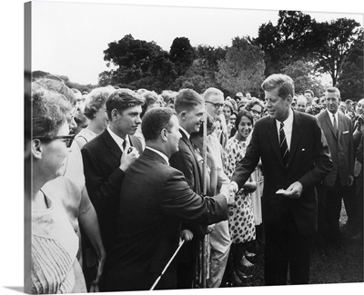 President Kennedy greets Peace Corps Volunteers on the White House South Lawn