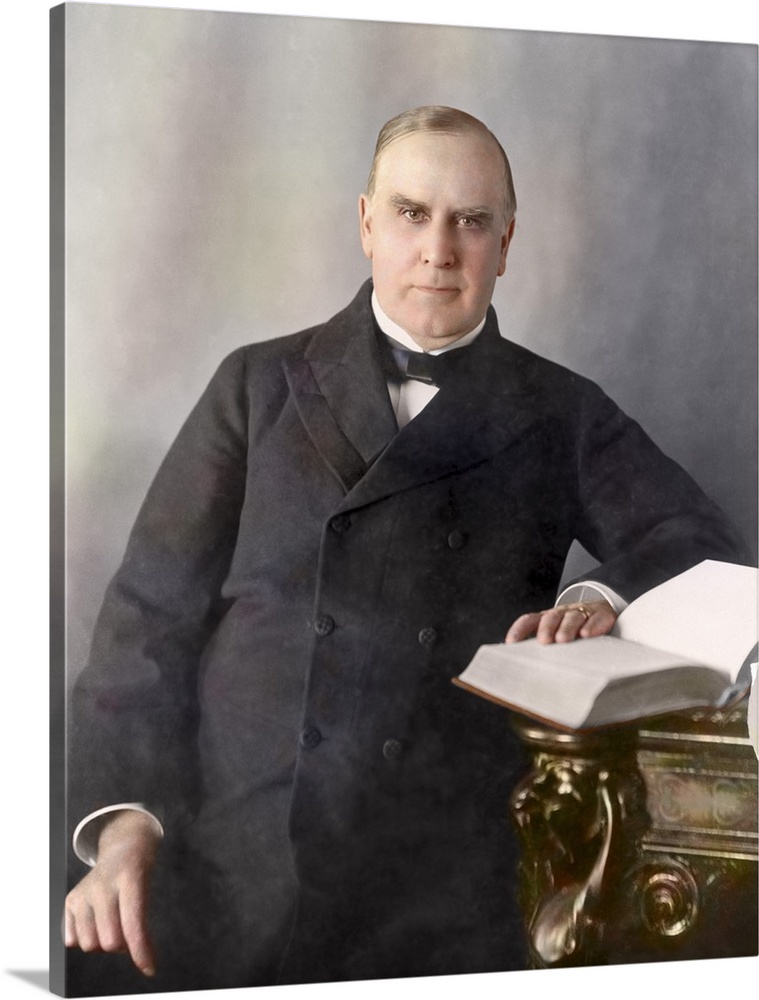 President William McKinley, half-length portrait, seated at desk, facing front, circa 1900.