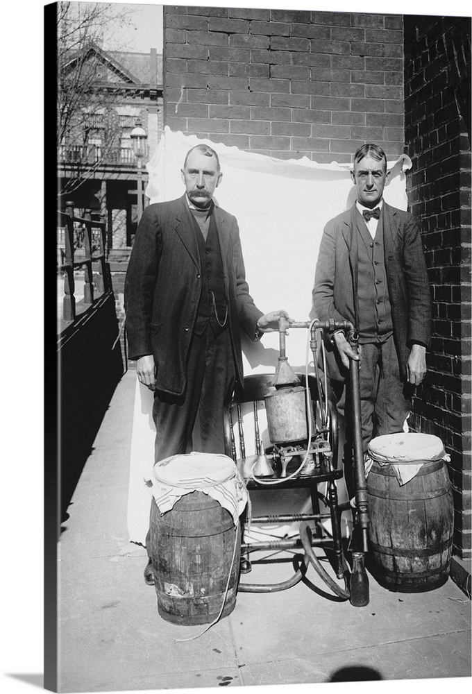 Prohibition era photograph of two men posing with an illegal whiskey still.