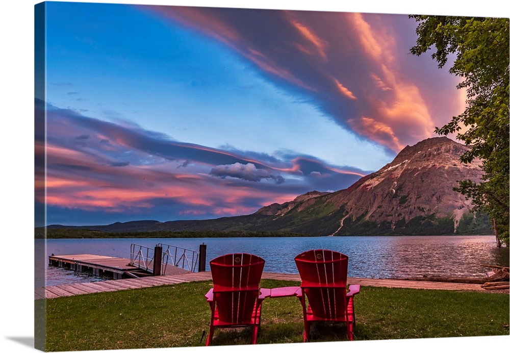Red chairs in the sunset light at Waterton Lakes National Park, Canada.