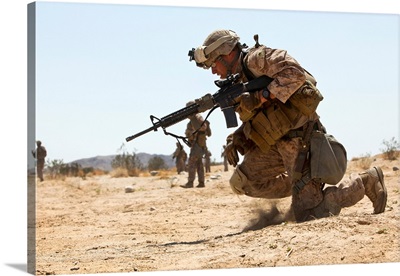 Rifleman kneels to the ground while conducting buddy rushes