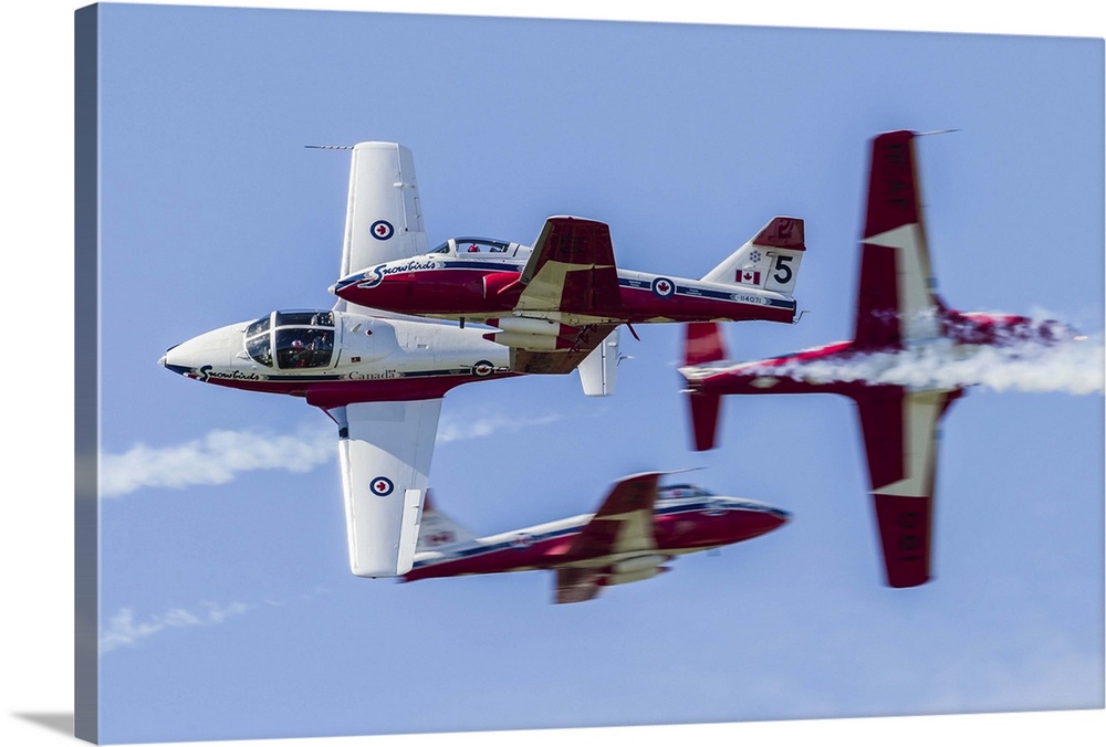 Four Royal Canadian Air Force Tutor trainer aircraft of the Snowbirds display team cross at Waukegan, Illinois.