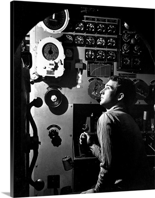 Sailor at work in the electric engine control room of USS Batfish