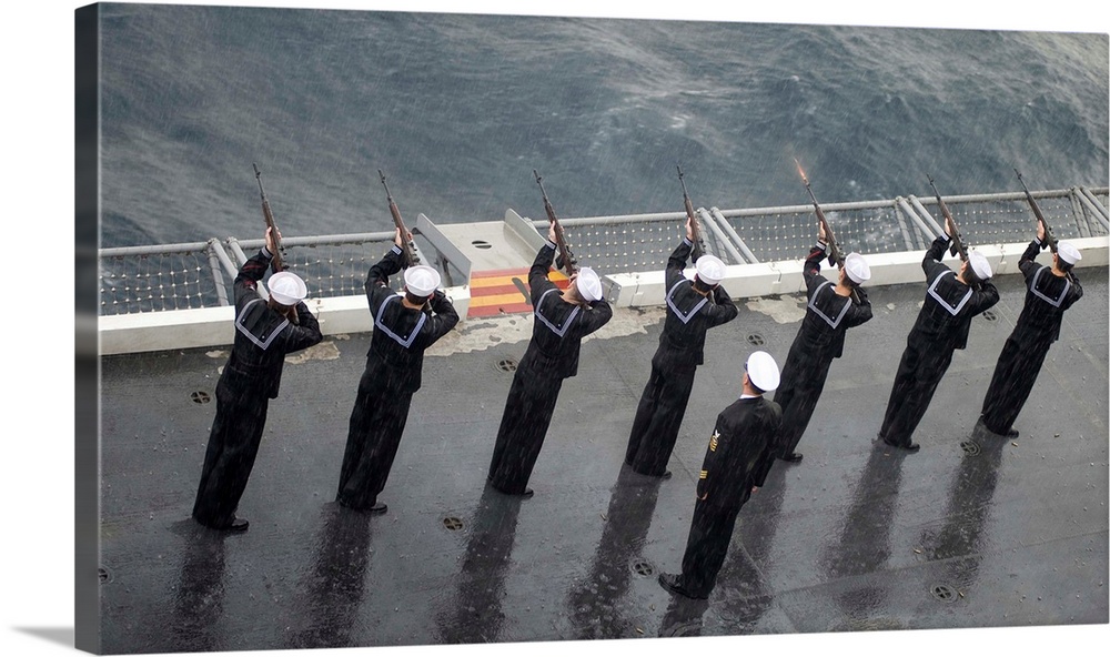 Atlantic Ocean, November 2, 2012 - Sailors fire a 21-gun salute during a burial at sea ceremony aboard the aircraft carrie...