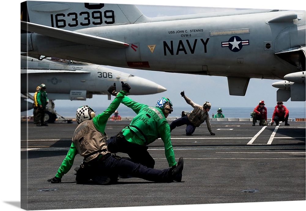 Sailors give launch approval for an EA-6B Prowler aboard USS John C. Stennis.
