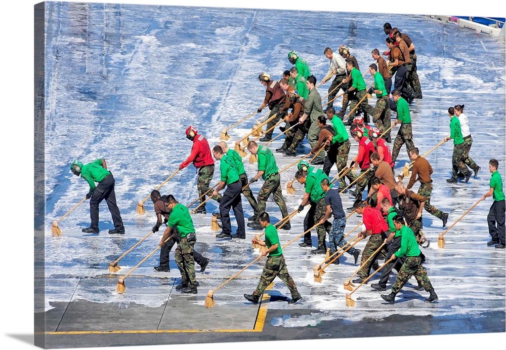 Sailors perform a flight deck wash down aboard the aircraft carrier USS George Washington.