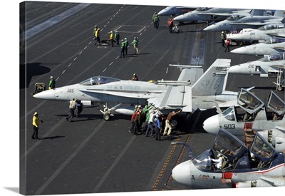 Sailors Push An F/A-18C Hornet In Preparation For Flight Operations