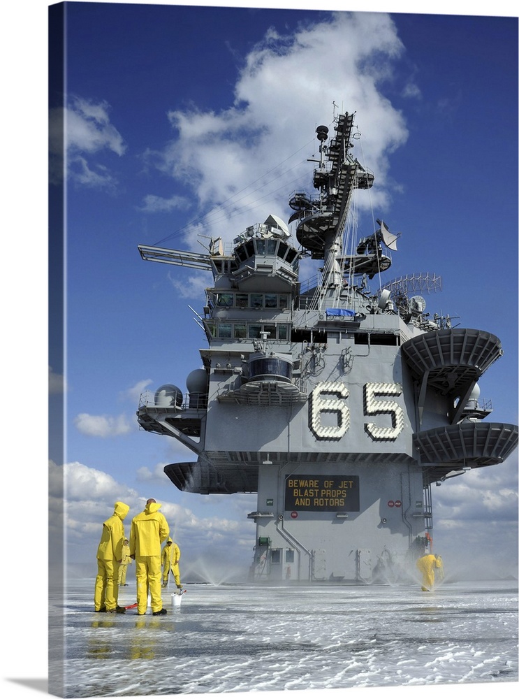 Air department Sailors test the sprinkler system on the flight deck of the USS Enterprise.