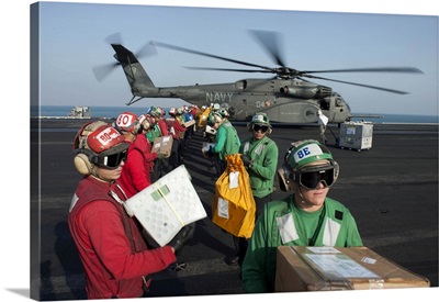 Sailors Unload Mail From An MH-53E Sea Dragon