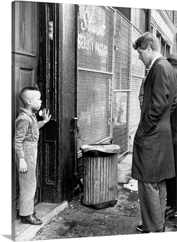 February 4th, 1966 - Senator Robert Kennedy discussing school with a young child in New York.